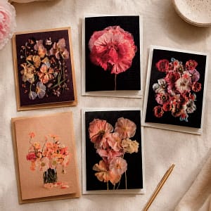 Flat lay of the complete Poppy Greeting Card Collection — five card designs with matching envelopes placed together